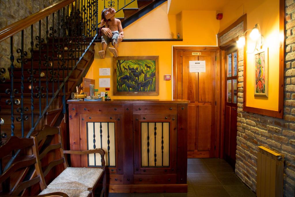 a room with a staircase and a woman sitting on the stairs at Hotel Balcon de Aguera in San Martín