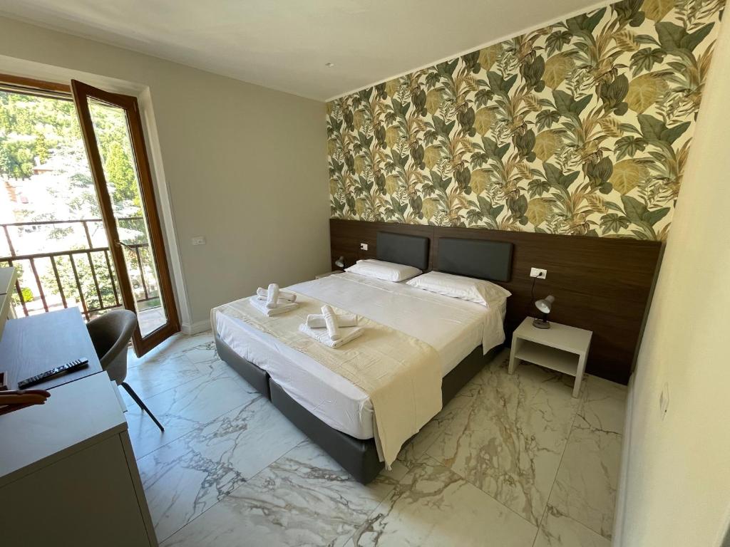 a bedroom with a large bed and a window at Corso 104 in Terracina