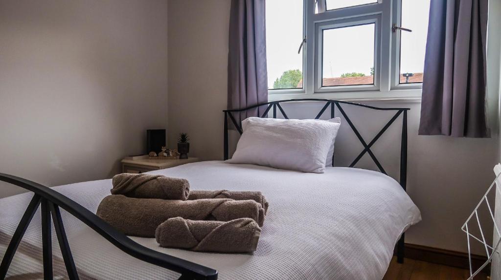a bedroom with a bed with towels on it at Cozy double room - Only room in London