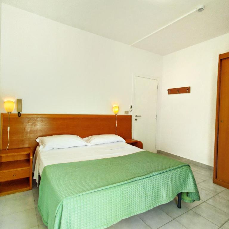 Postel nebo postele na pokoji v ubytování Piccolo Hotel