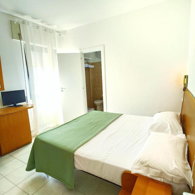 Postel nebo postele na pokoji v ubytování Piccolo Hotel