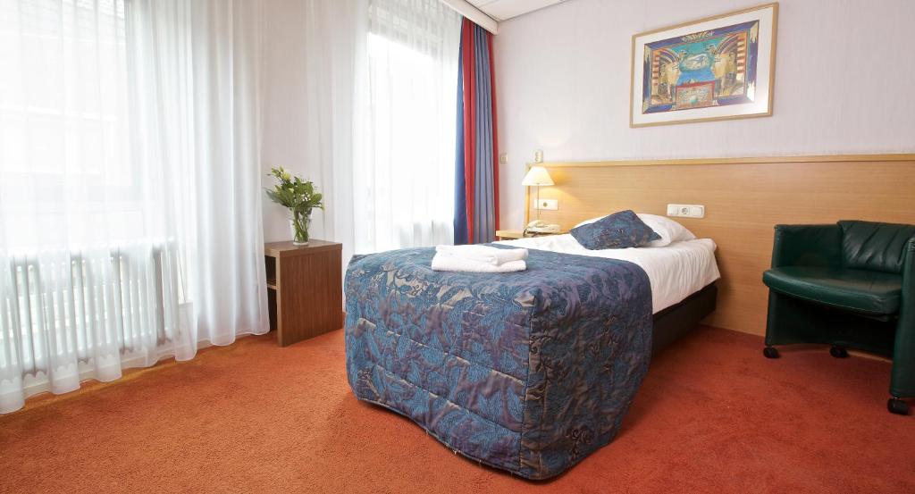 Postel nebo postele na pokoji v ubytování Hampshire Hotel Petit Nord