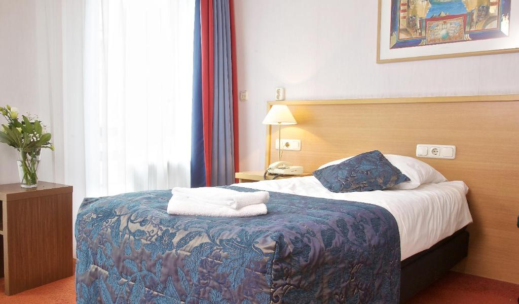 Postel nebo postele na pokoji v ubytování Hampshire Hotel Petit Nord