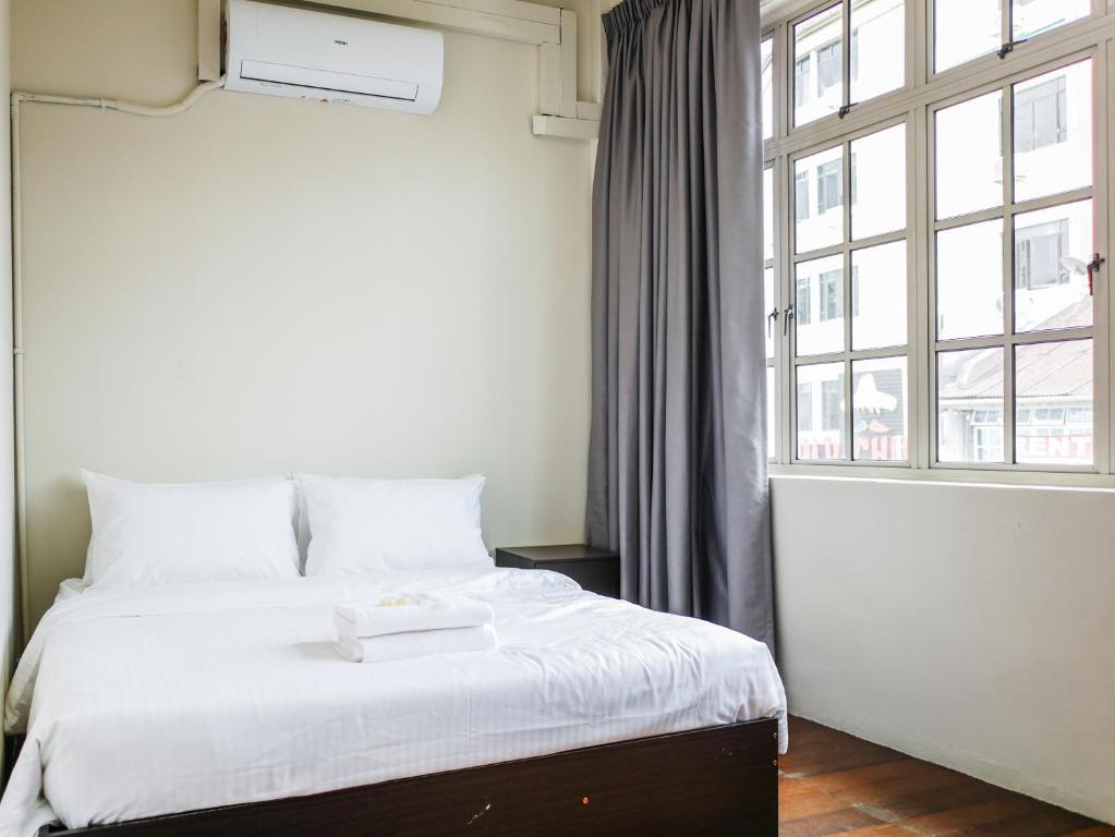 Postel nebo postele na pokoji v ubytování Aayu Chulia - Chulia St, George Town
