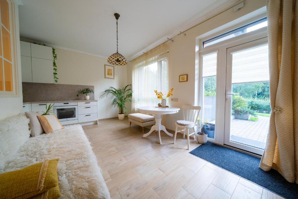 a living room with a couch and a table at Cozy apartment in Santariškės in Vilnius