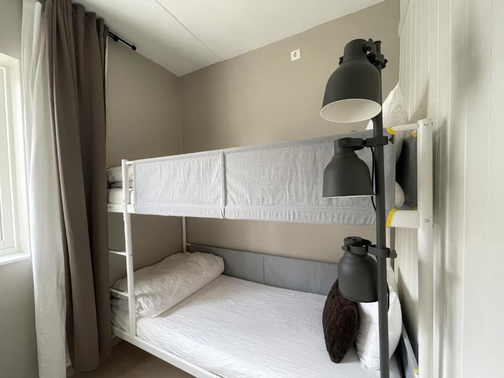 a bedroom with two bunk beds and a lamp at The Hedge Apartments in Oslo