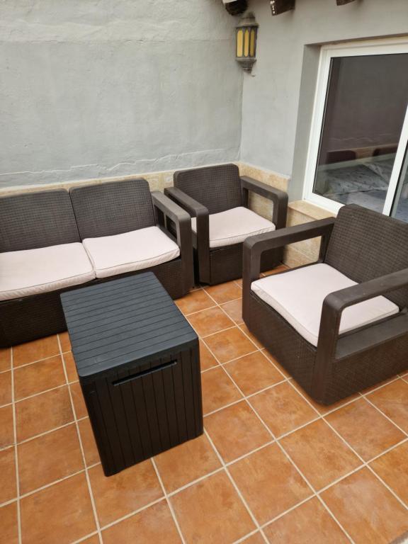a living room with three couches and a coffee table at Casa con terraza a 10min de la playa in Cullera