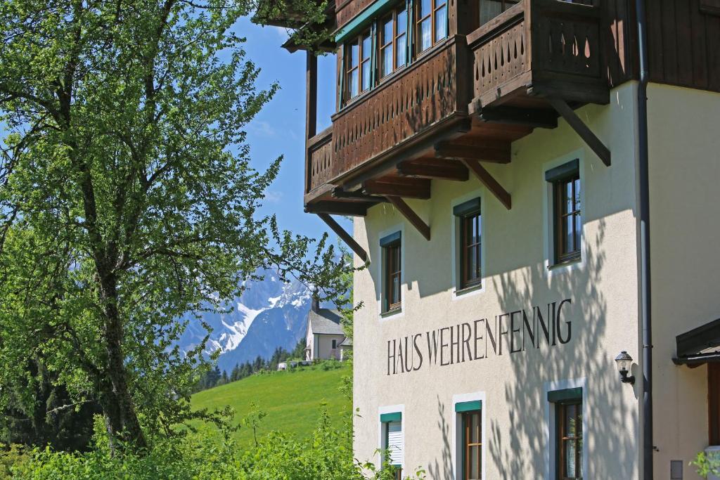 a building with a balcony on the side of it at Appartementhaus Wehrenfennig in Gosau