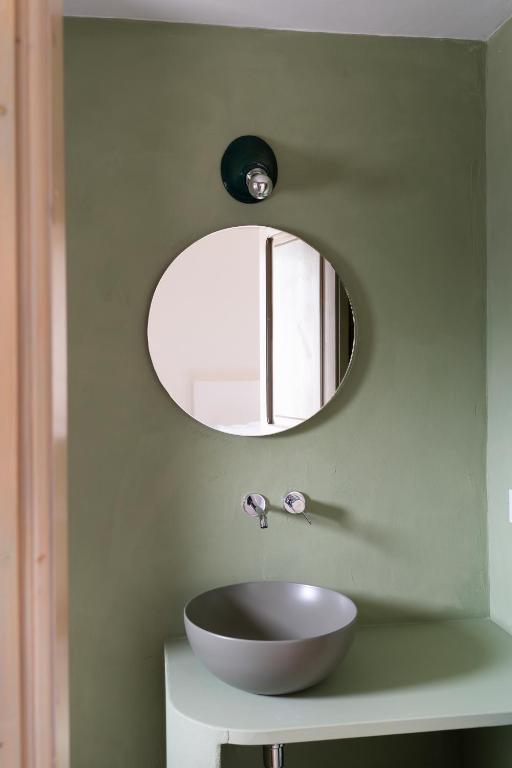 a bathroom with a bowl sink and a mirror at Masseria Gorgognolo in Ostuni