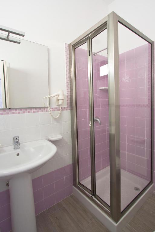 a bathroom with a sink and a shower at Venustas in Lampedusa
