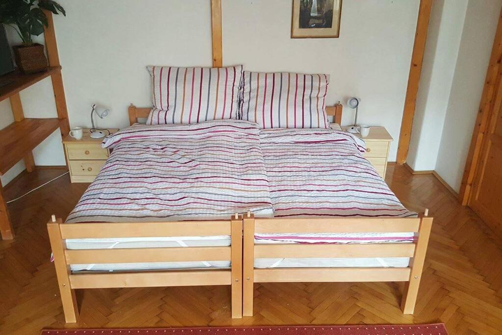 a large bed with a striped comforter in a bedroom at Sugar House City Center Apartment in Budapest