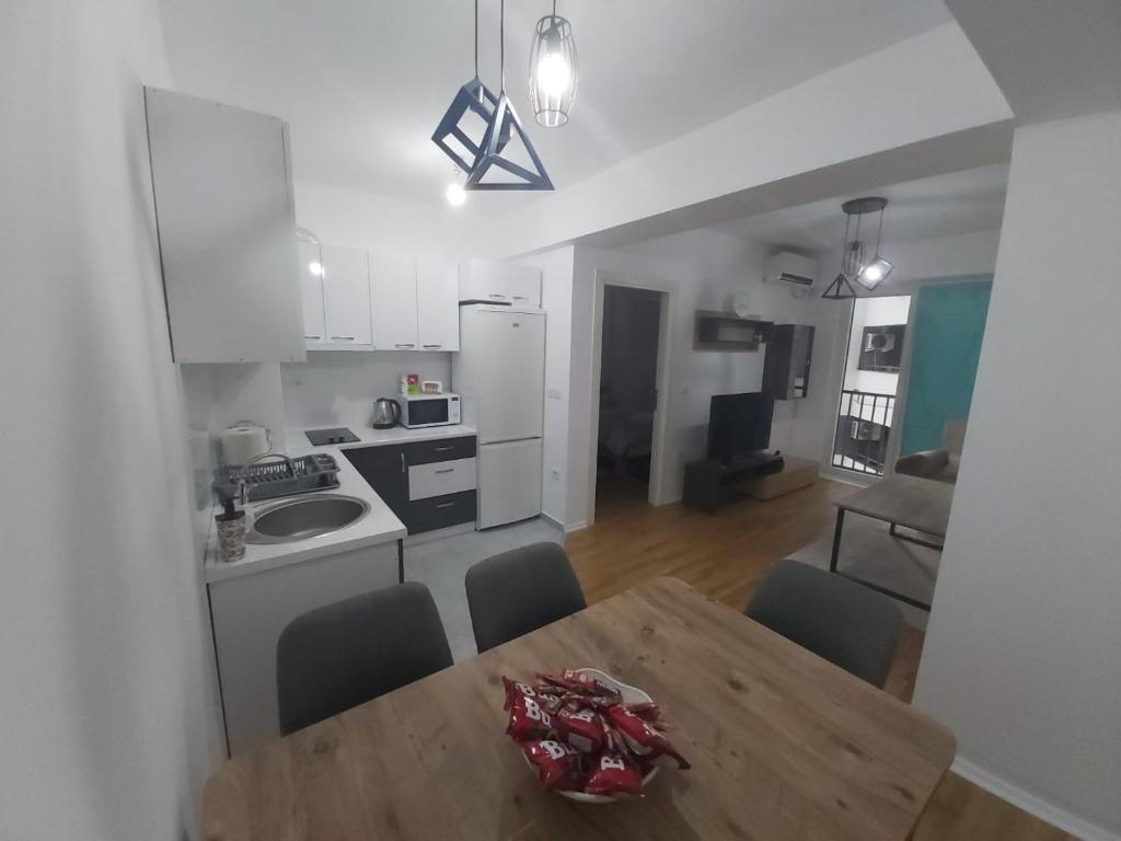 a kitchen and dining room with a table and chairs at Kosara in Skopje