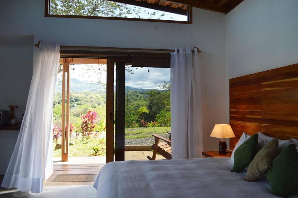 a bedroom with a bed and a large glass door at Luxury Villa Caoba- Private, Serene, Amazing Views in San Mateo