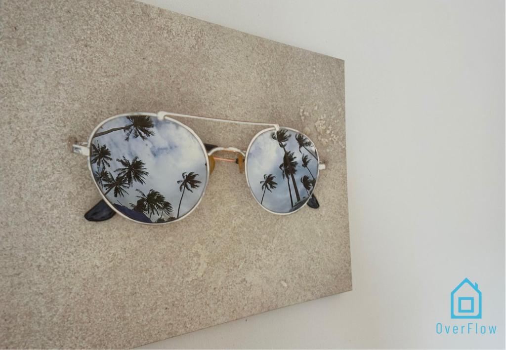 a pair of sunglasses with palm trees in the lenses at Ocular Room in Gdańsk
