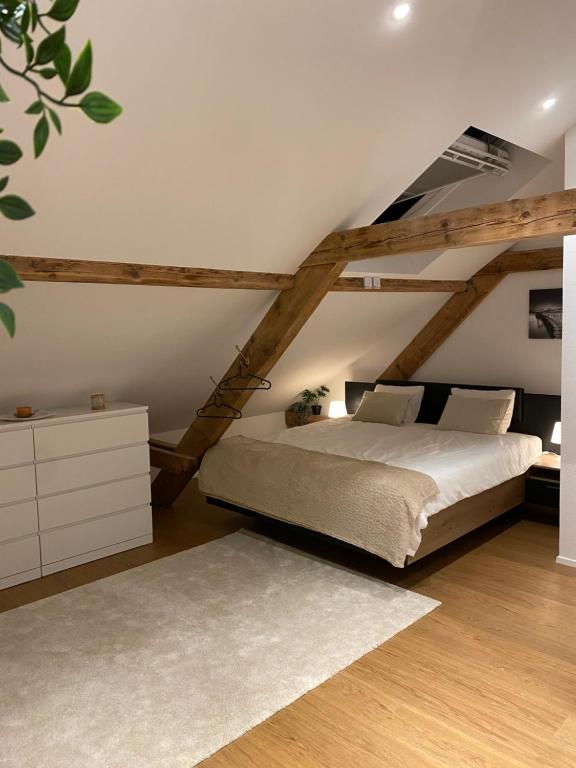 a bedroom with a large bed in a attic at Eine schöne Wohnung an der Birs in Basel