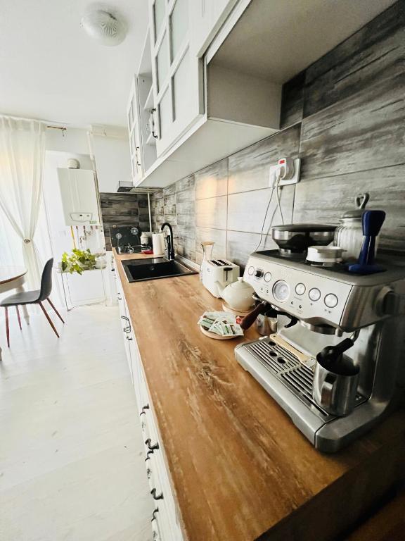 a kitchen with a stove and a counter top at The Airport Loft in Otopeni