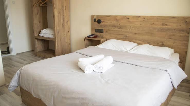 a bedroom with a white bed with two towels at brilliant hotel in Bolu