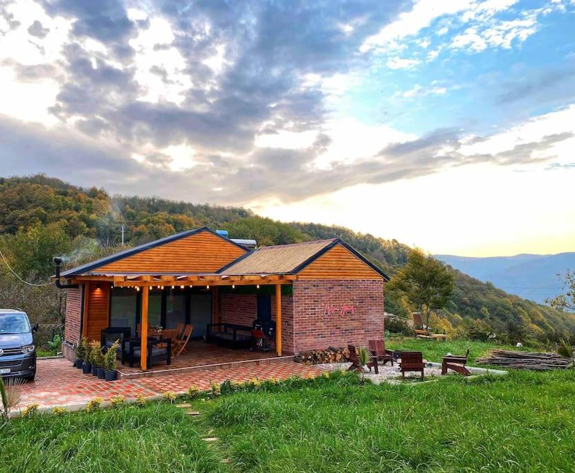 a small house with a patio in a field at eşsiz doğa manzarasında jakuzi keyfi sunan dağ evi in Gölcük