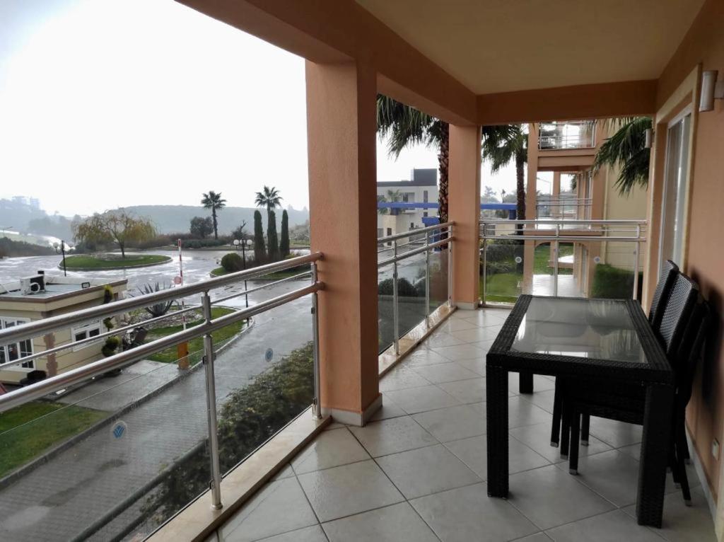 a balcony with a table and a view of a street at Bu Daire Kalıcı olarak Sistemden cikmistir in Kuşadası