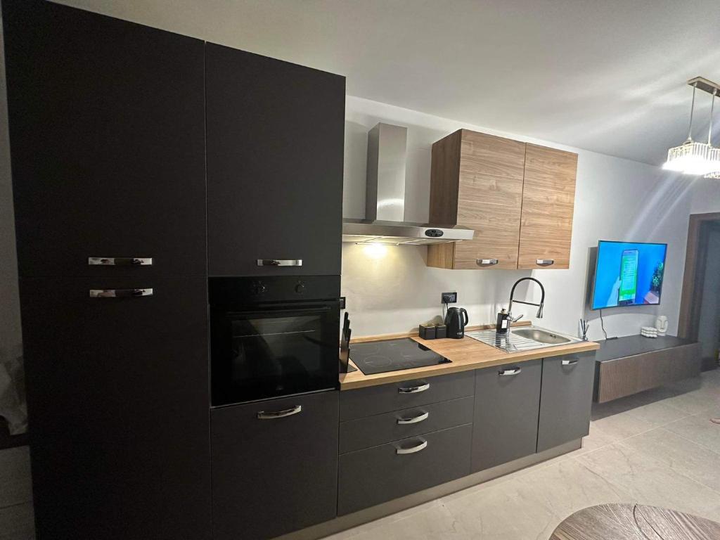 a kitchen with black cabinets and a counter top at Lucas holiday home in Tal-Pietà