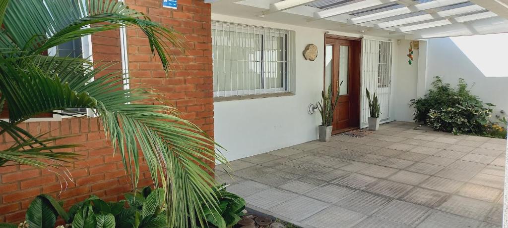 a porch of a house with a brick wall at Aeropuerto a 5' y Ruta del Vino a 100 mts in Salta