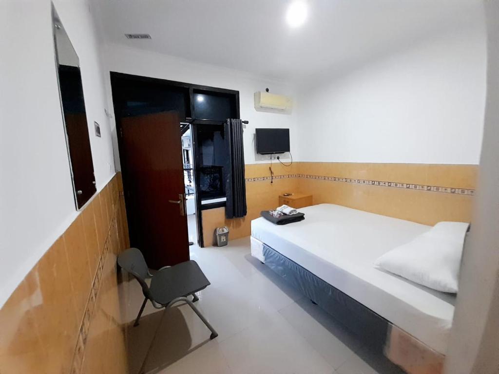 Postel nebo postele na pokoji v ubytování Hotel Srikandi Baru