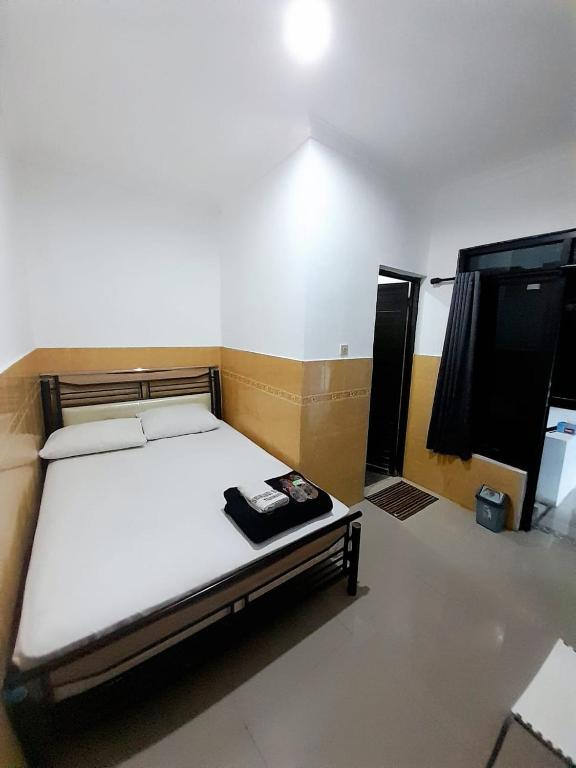 Postel nebo postele na pokoji v ubytování Hotel Srikandi Baru