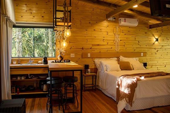 1 dormitorio con 1 cama y cocina con fregadero en Valle Das Águas, en Urubici