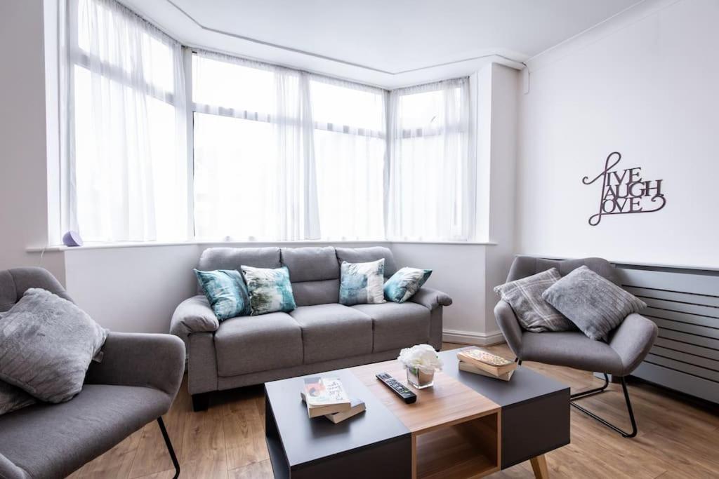 a living room with two couches and a coffee table at Windsor House 3 Bedrooms Sleeps 8 in Manchester