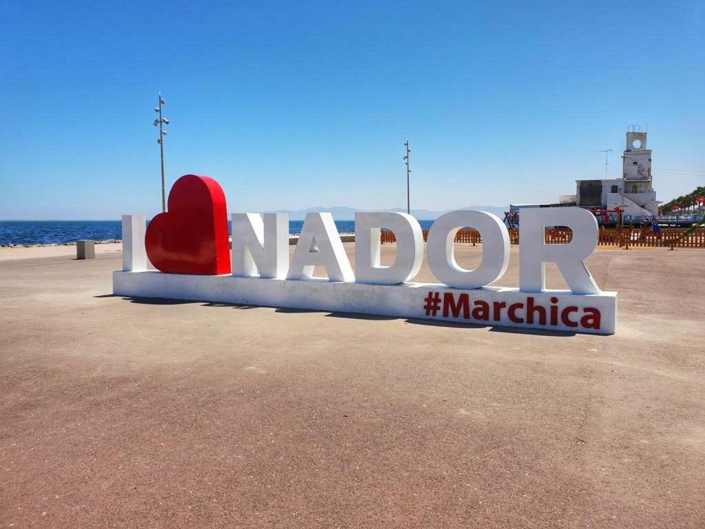 a sign for a beach with a red heart at Appartement de Lux Hay Al MATAR in Nador