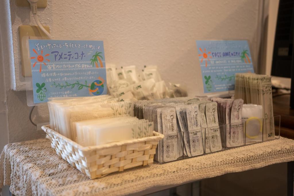 a table topped with lots of candles and books at Kerama Blue Resort in Zamami