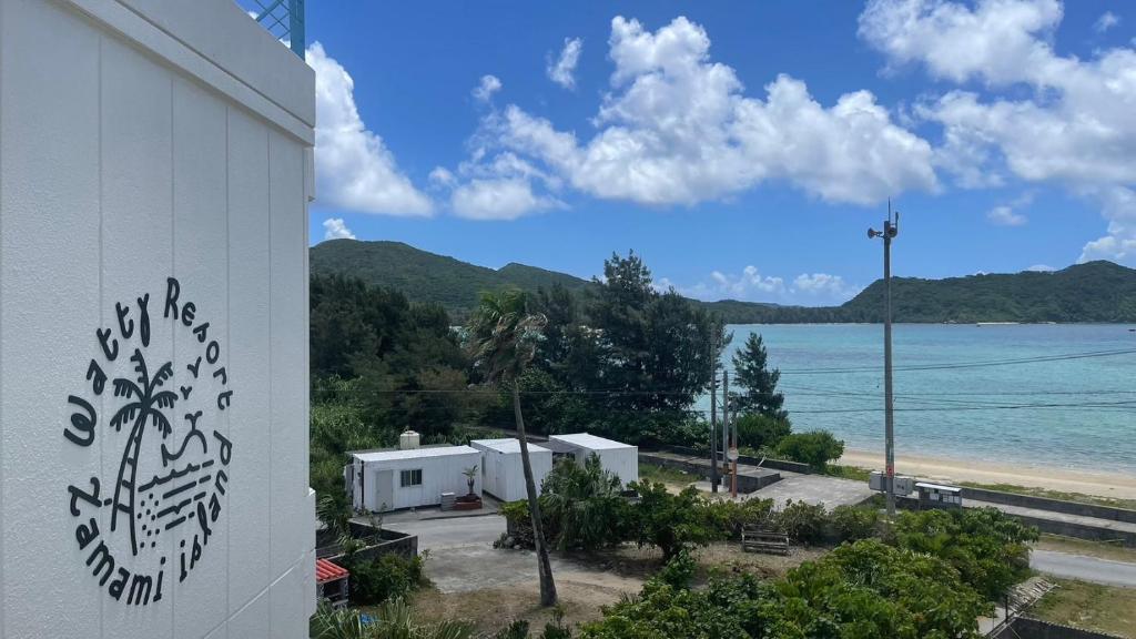 a building with a view of a body of water at Kerama Blue Resort in Zamami