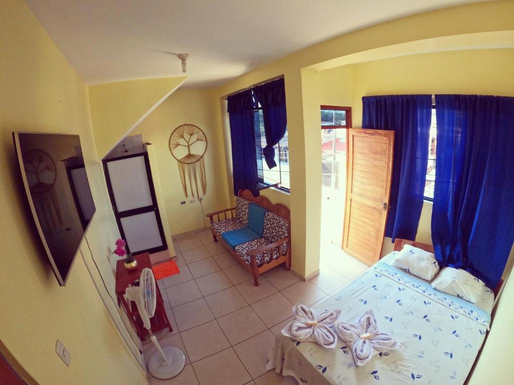 a childs bedroom with a bed and a chair at Shoffi's House Backpackers in Tarapoto