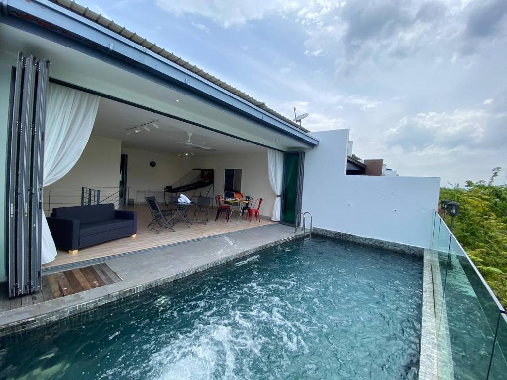 a villa with a swimming pool and a house at Puchong New Private Pool & Jacuzzi up to 30 Pax in Puchong