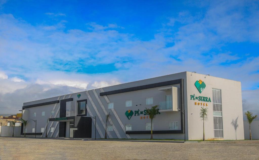 a white building with a sign on the side of it at Hotel Pé de Serra in Nossa Senhora da Glória