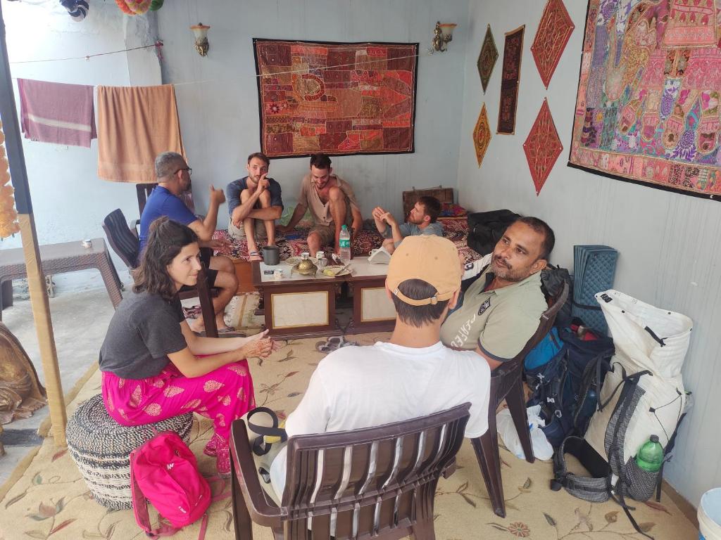 a group of people sitting around a table at Little prince guest house & homestay in Bikaner