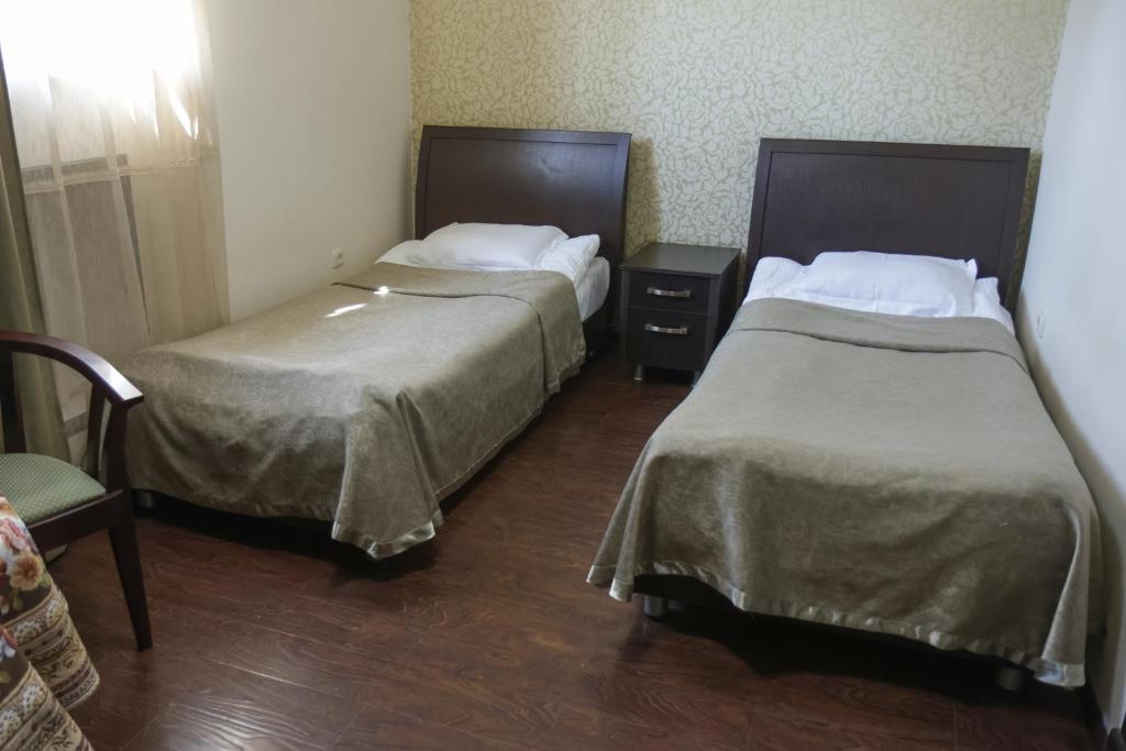 Postel nebo postele na pokoji v ubytování Parvana Hotel