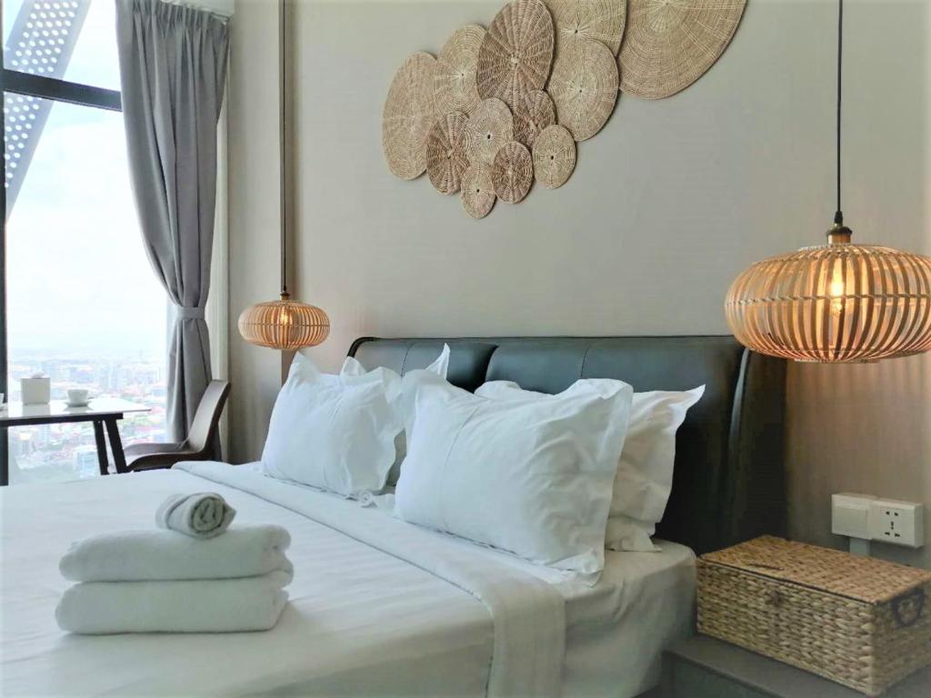 a bedroom with a bed with white sheets and pillows at City View Studio Unit in Phnom Penh