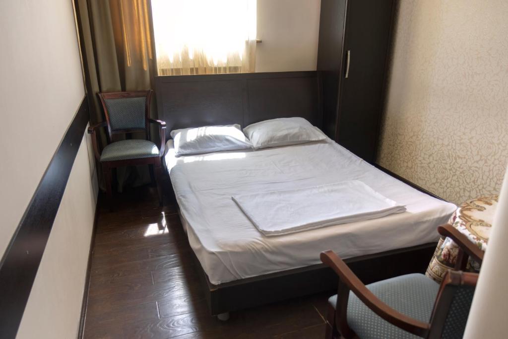 Postel nebo postele na pokoji v ubytování Parvana Hotel