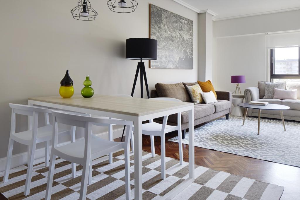 a living room with a white table and chairs at Duke by FeelFree Rentals in San Sebastián