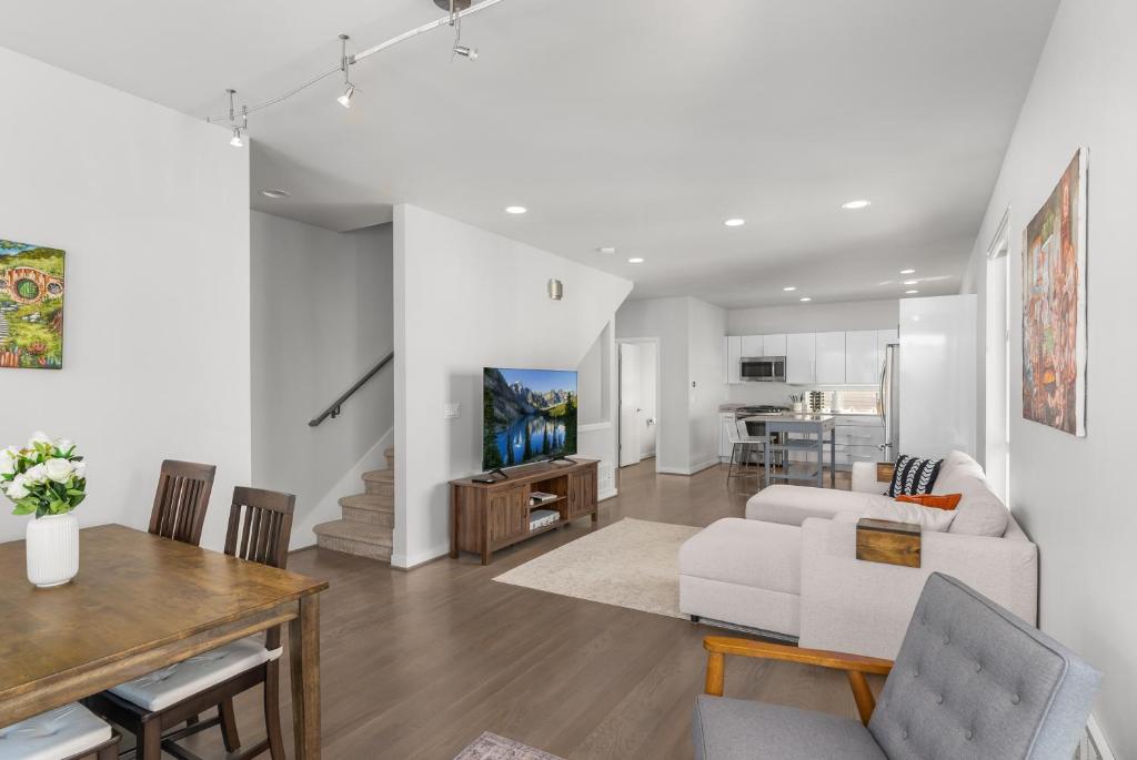 a living room with a couch and a table at Modern Luxury Home with EV Garage, Office, Bike & Balcony, WFH & Family Friendly in Seattle