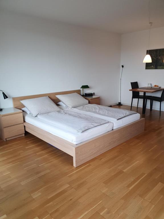 a large bed in a room with a wooden floor at Apartment B311 mit Pool in Lahnstein