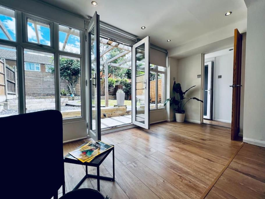 a living room with wooden floors and large glass doors at Entire Modern House in Tamworth - 2 Double Beds + Free Parking in Tamworth