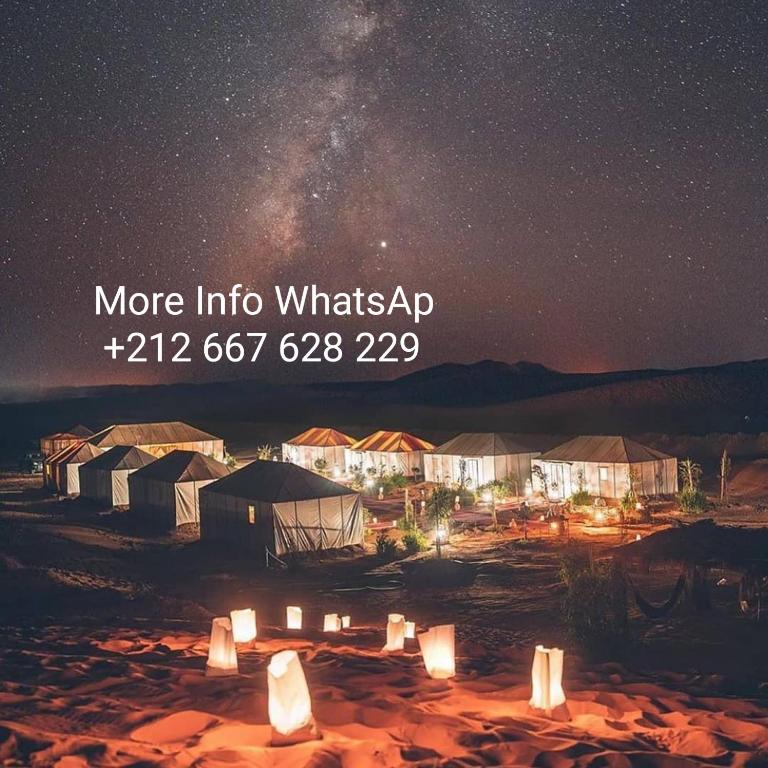 a starry night with the words more into whatsapp at Desert Lover's Luxury Camp in Merzouga