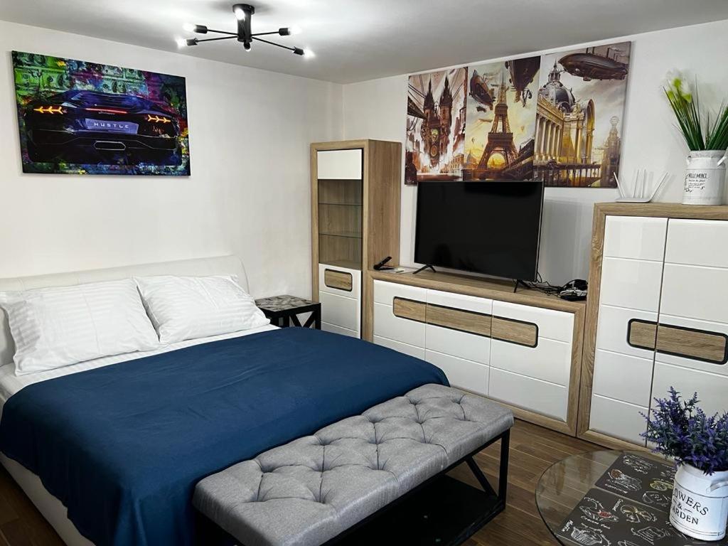 sypialnia z łóżkiem i telewizorem z płaskim ekranem w obiekcie Apartment IRON CUBE w Pradze