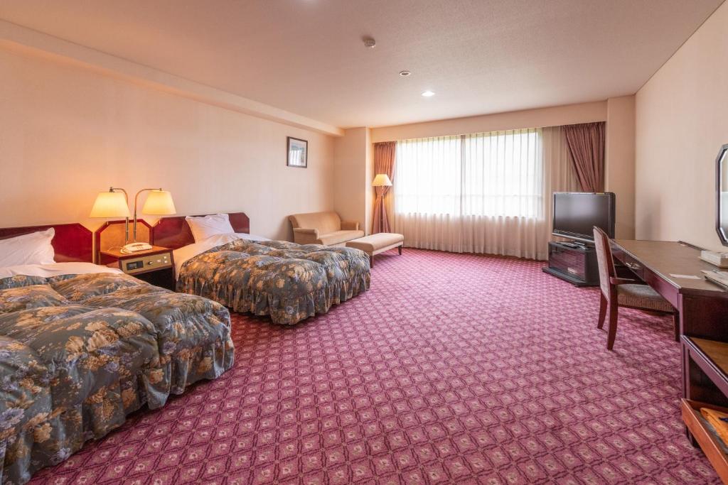 Postel nebo postele na pokoji v ubytování Yuzawa Toei Hotel