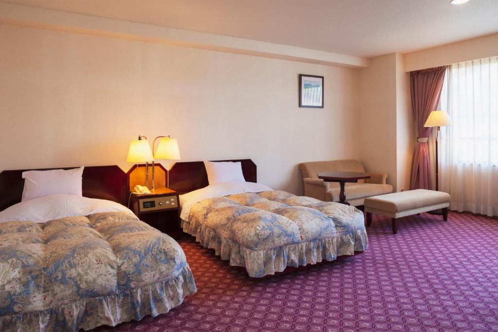Postel nebo postele na pokoji v ubytování Yuzawa Toei Hotel