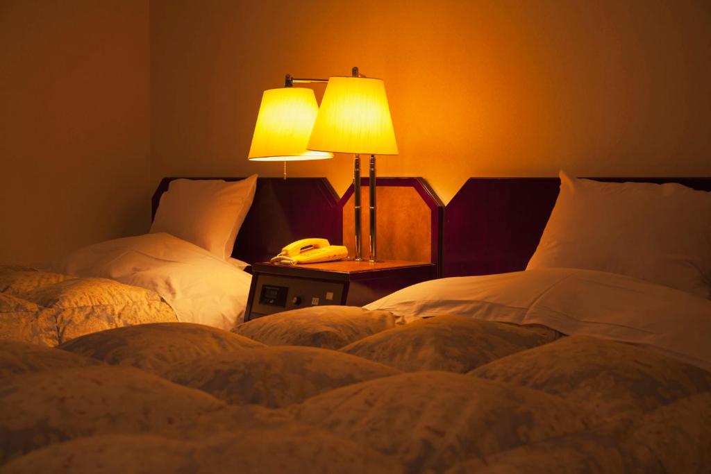 Postel nebo postele na pokoji v ubytování Yuzawa Toei Hotel