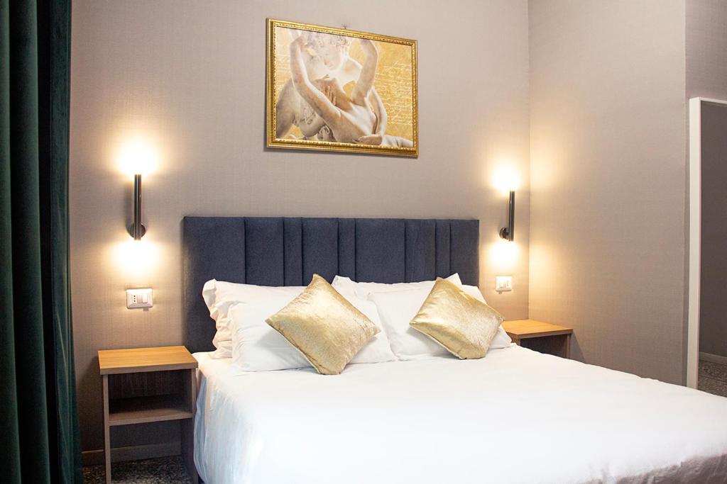 a bedroom with a large white bed with two pillows at Vatican museum guest house in Rome