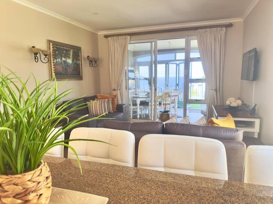 a living room with a couch and a table at Luxury Lifestyle Villa in Mossel Bay